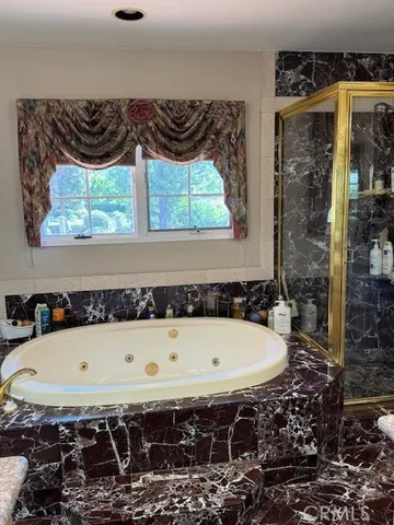 a bathroom with a bathtub and a window