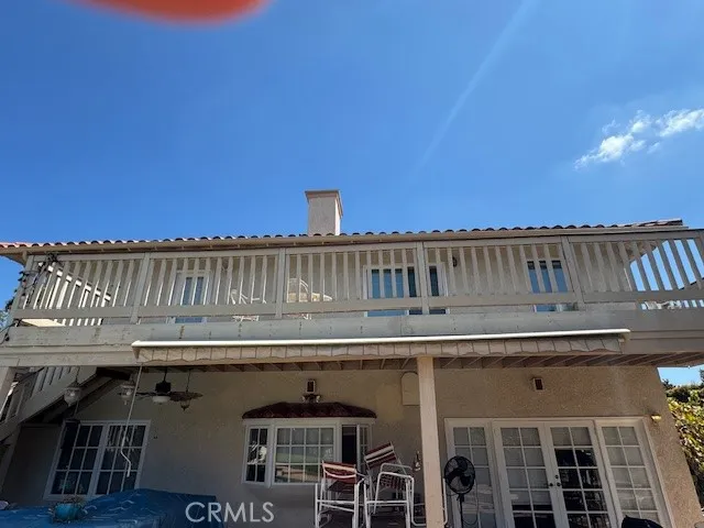 a roof deck with table and chairs
