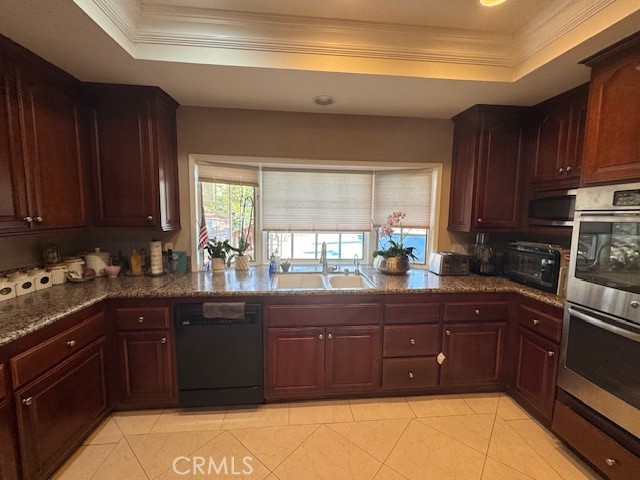 10821 Vida Drive Villa Park, CA 92861 - Photo 3 of 39 a kitchen with a sink a stove and wooden cabinets