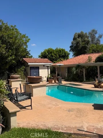 a view of a house with swimming pool and a garden