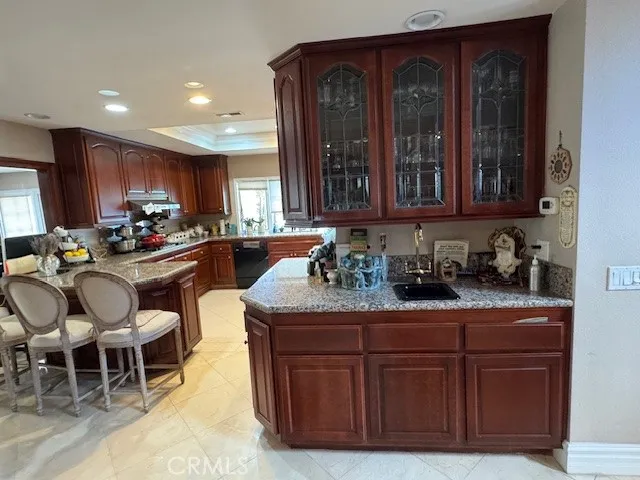 a kitchen with kitchen island granite countertop a sink and chairs