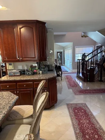 a kitchen with granite countertop a sink and cabinets