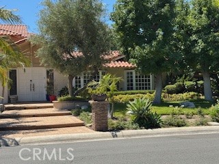 10821 Vida Drive Villa Park, CA 92861 - Photo 9 of 39 a view of a house with potted plants and large trees