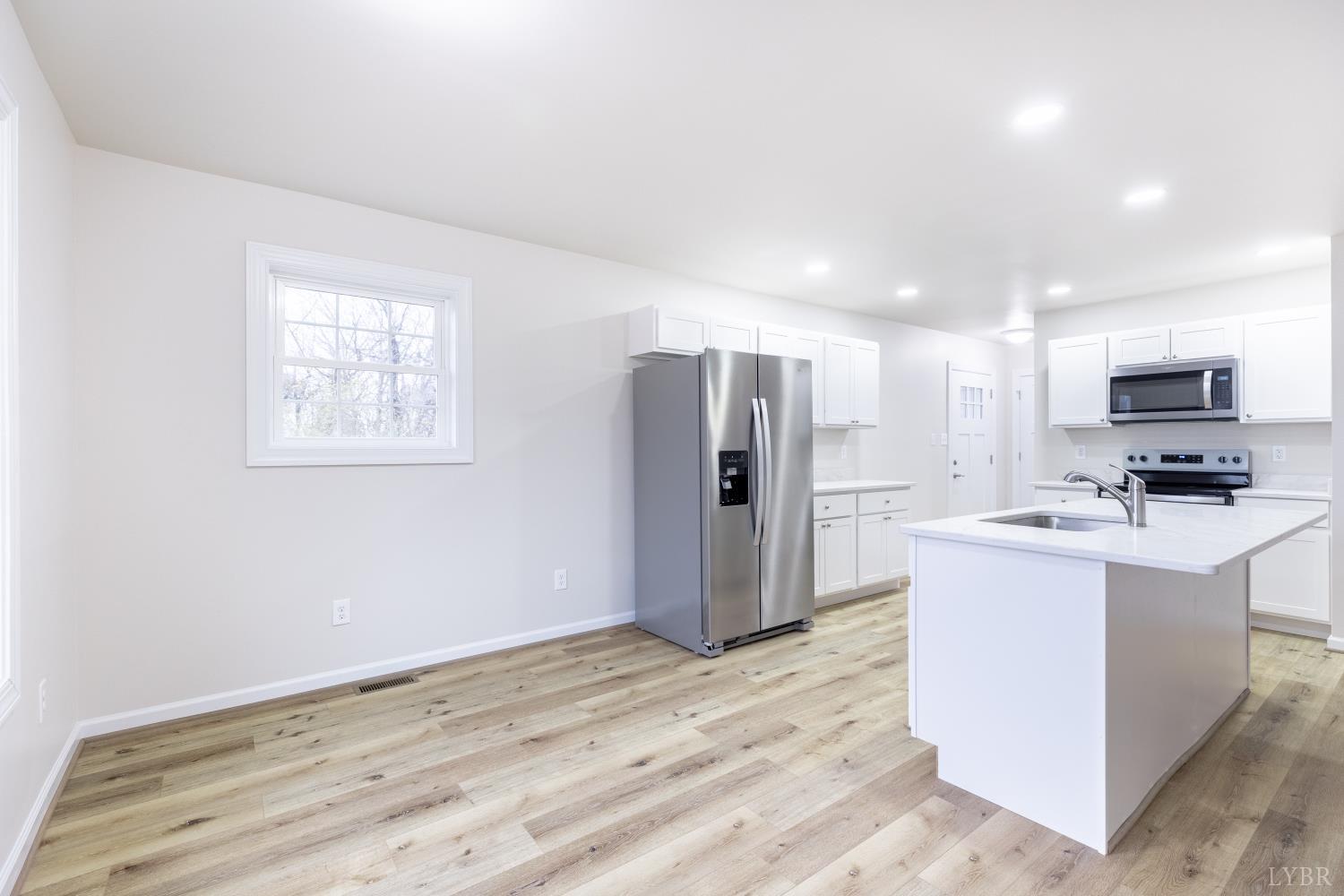 1104 15th Street Altavista, VA 24517 - Photo 11 of 47 a view of kitchen with stainless steel appliances kitchen island a sink dishwasher a refrigerator and a stove with wooden floor