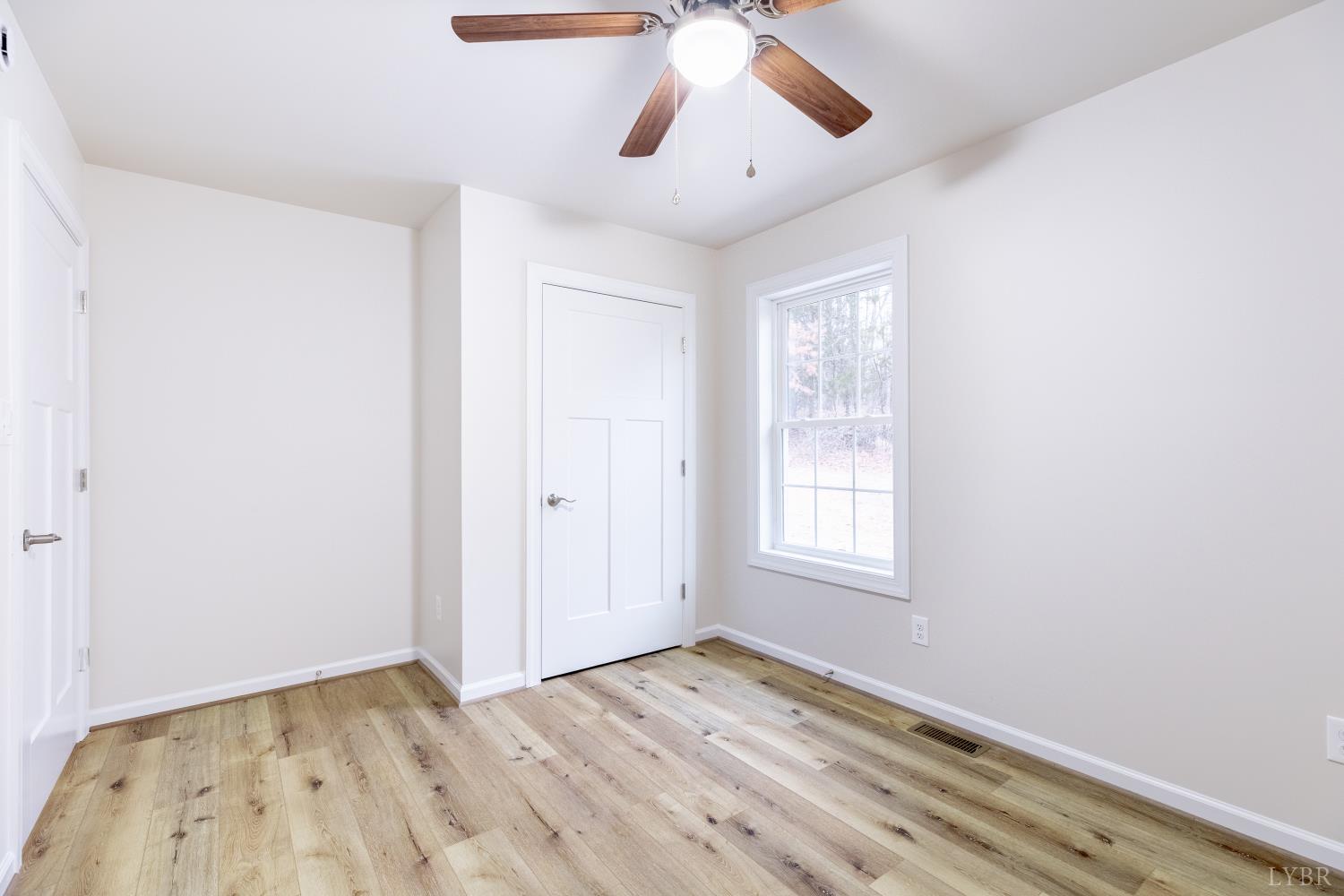 1104 15th Street Altavista, VA 24517 - Photo 23 of 47 a view of an empty room with window and wooden floor