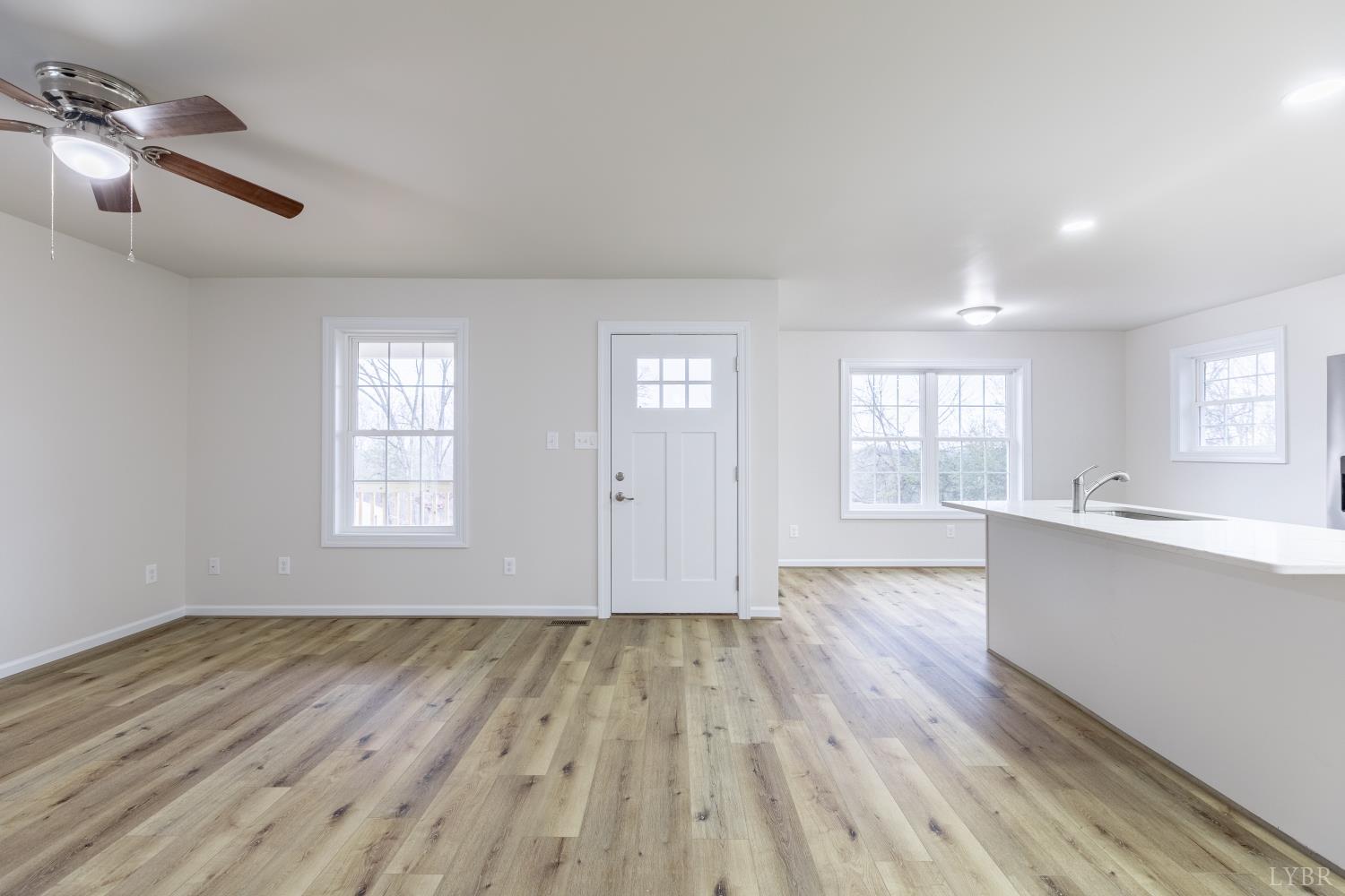 1104 15th Street Altavista, VA 24517 - Photo 6 of 47 an empty room with wooden floor and windows