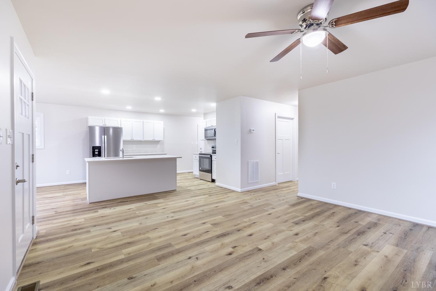 1104 15th Street Altavista, VA 24517 - Photo 8 of 47 a view of kitchen and empty room with wooden floor