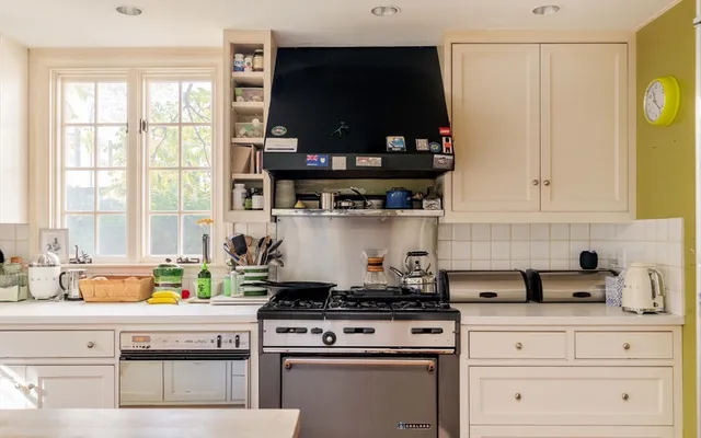a kitchen with stainless steel appliances granite countertop a stove and a microwave