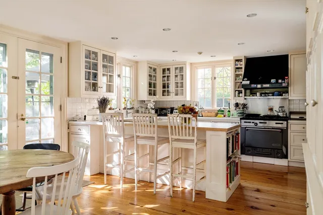 a kitchen with stainless steel appliances kitchen island granite countertop a stove and a refrigerator