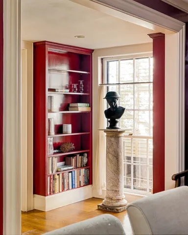a living room with furniture cabinets and window