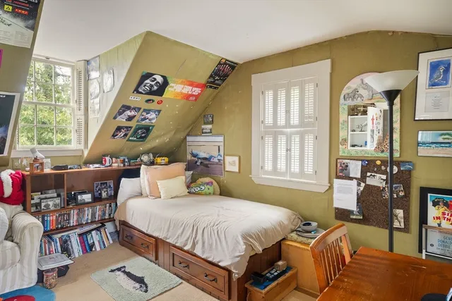 a bed room with a bed and a large window