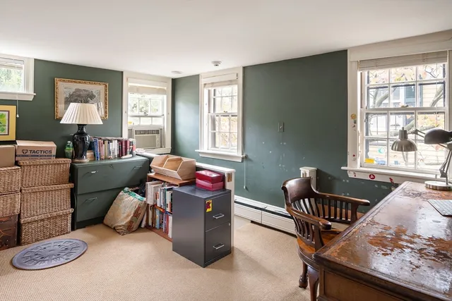 a livingroom with workspace and a window