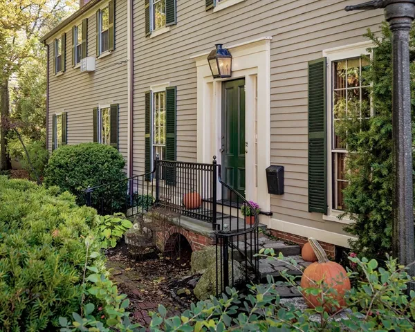 a view of a chair and table in backyard of the house