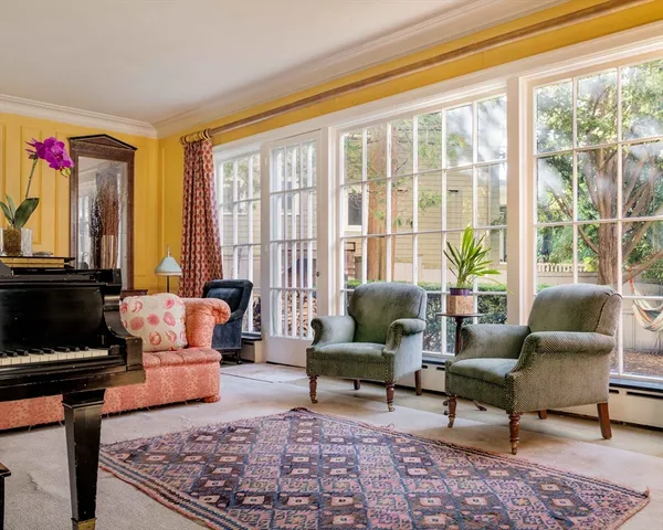 a living room with furniture and a floor to ceiling window
