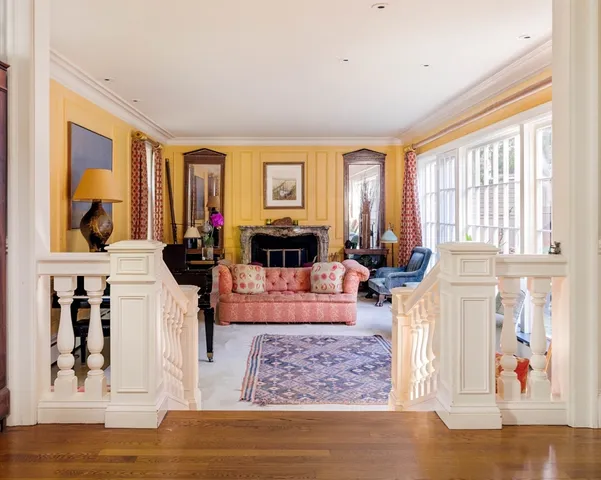 a living room with furniture large window and flat screen tv