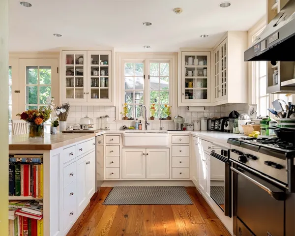 a kitchen with cabinets appliances and a window