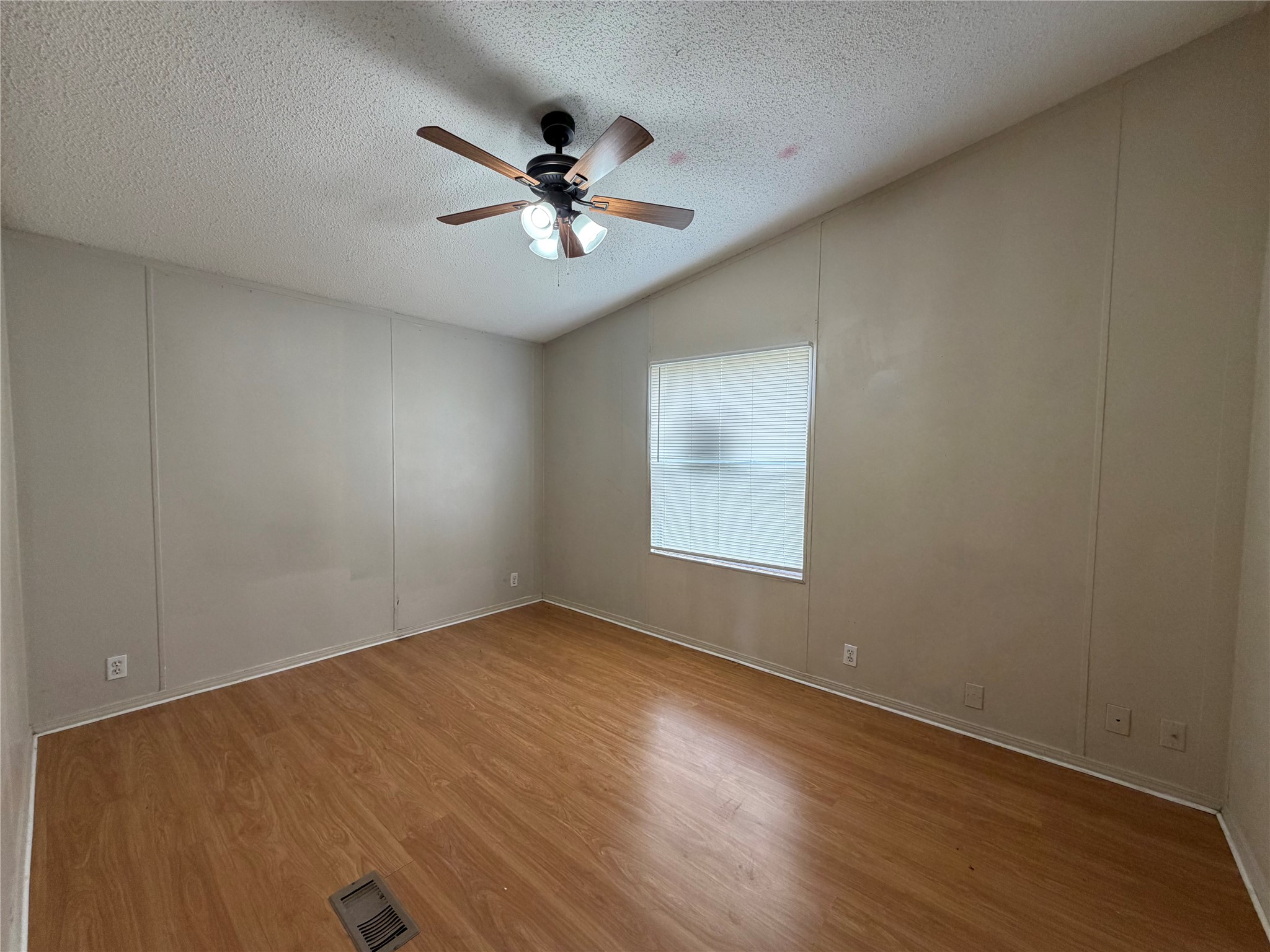12609 Dessau Road, Unit 410 Austin, TX 78754 - Photo 7 of 11 Room featuring wood-finish flooring, a window with horizontal blinds, and a ceiling fan with integrated lighting