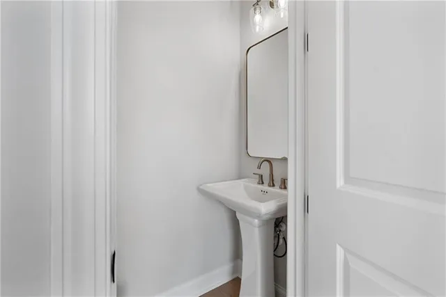 a bathroom with a sink a mirror and shower