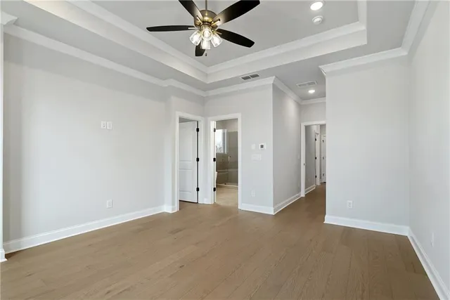 an empty room with closet and a chandelier fan