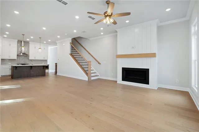 a view of an empty room with a fireplace and window