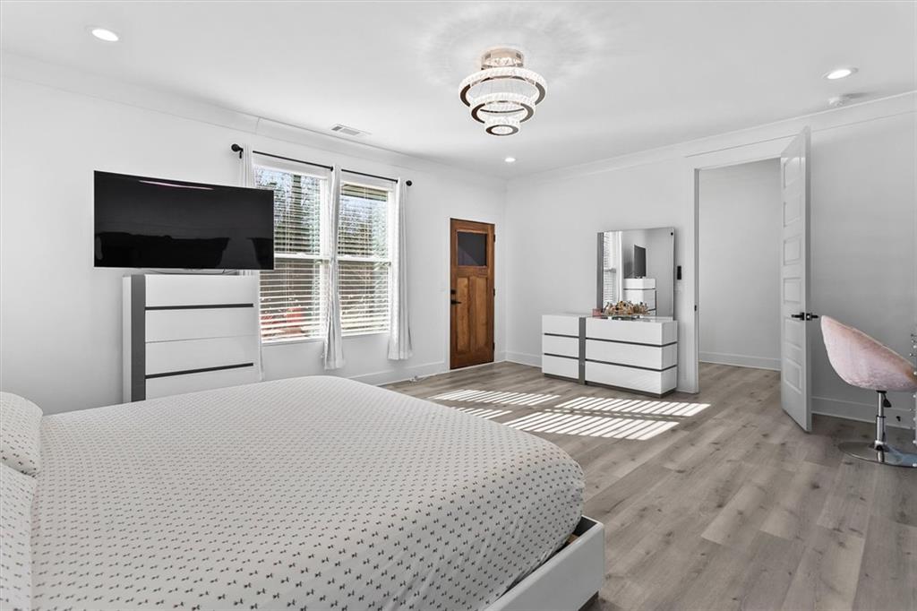 658 Rockbridge Road Northwest Lilburn, GA 30047 - Photo 16 of 61 a bedroom with a bed and a flat screen tv