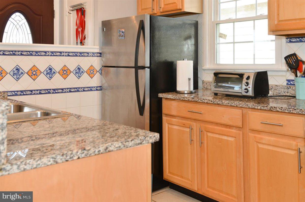 3312 Clay Street Silver Spring, MD 20902 - Photo 12 of 35 a kitchen with granite countertop cabinets and a refrigerator