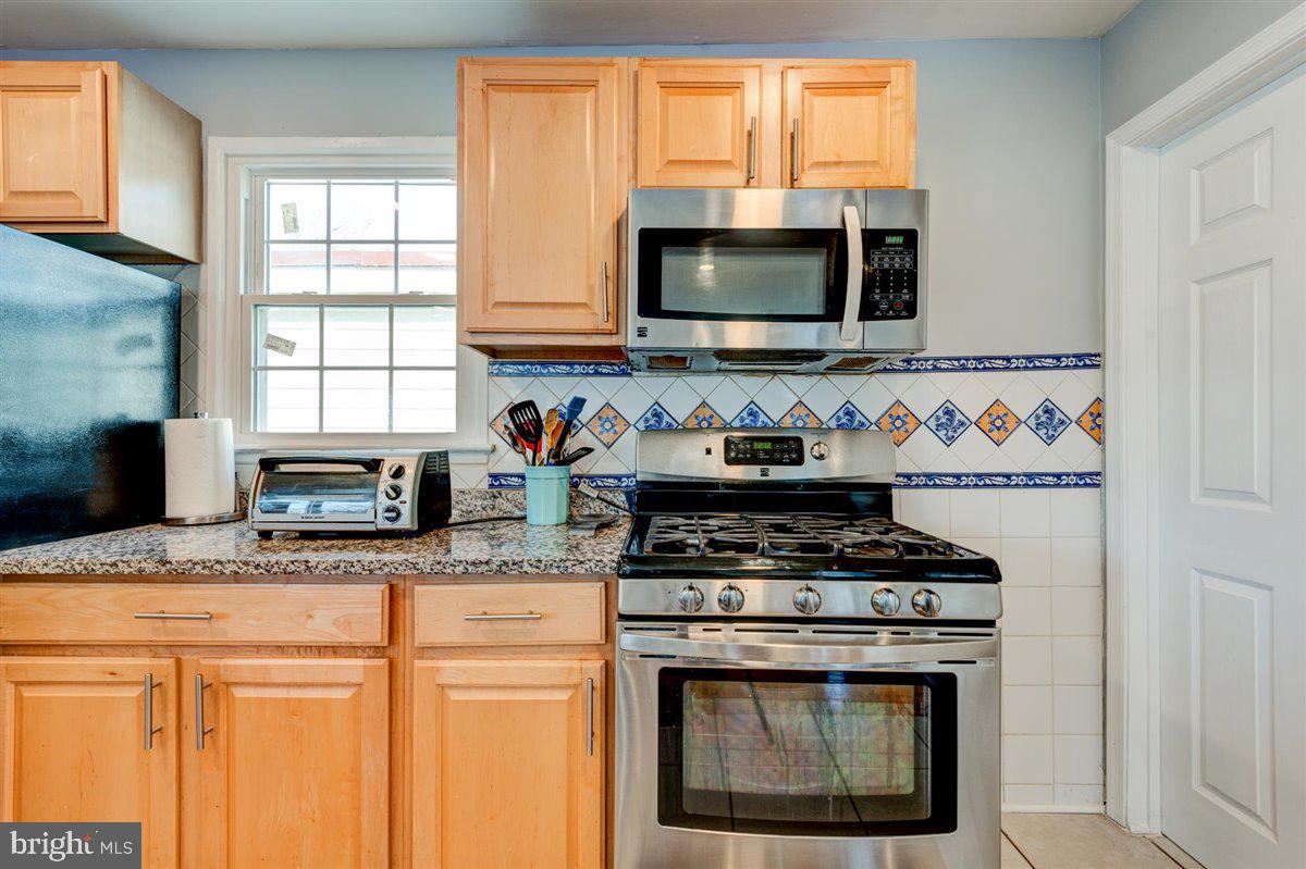 3312 Clay Street Silver Spring, MD 20902 - Photo 13 of 35 a kitchen with stainless steel appliances granite countertop a stove microwave and sink