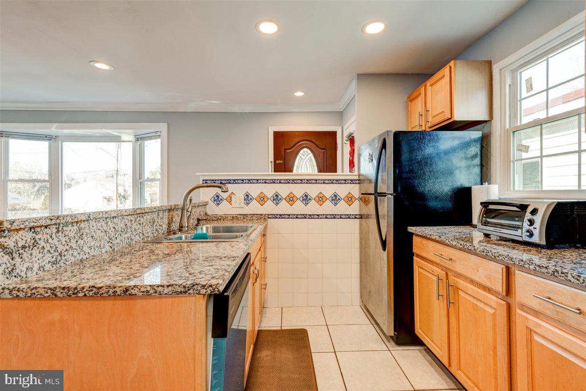 3312 Clay Street Silver Spring, MD 20902 - Photo 14 of 35 a kitchen with granite countertop sink stove and cabinets