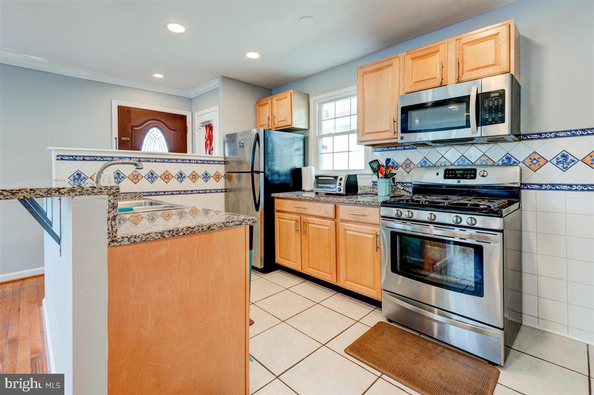 3312 Clay Street Silver Spring, MD 20902 - Photo 15 of 35 a kitchen with stainless steel appliances granite countertop a stove top oven a sink and a granite counter tops