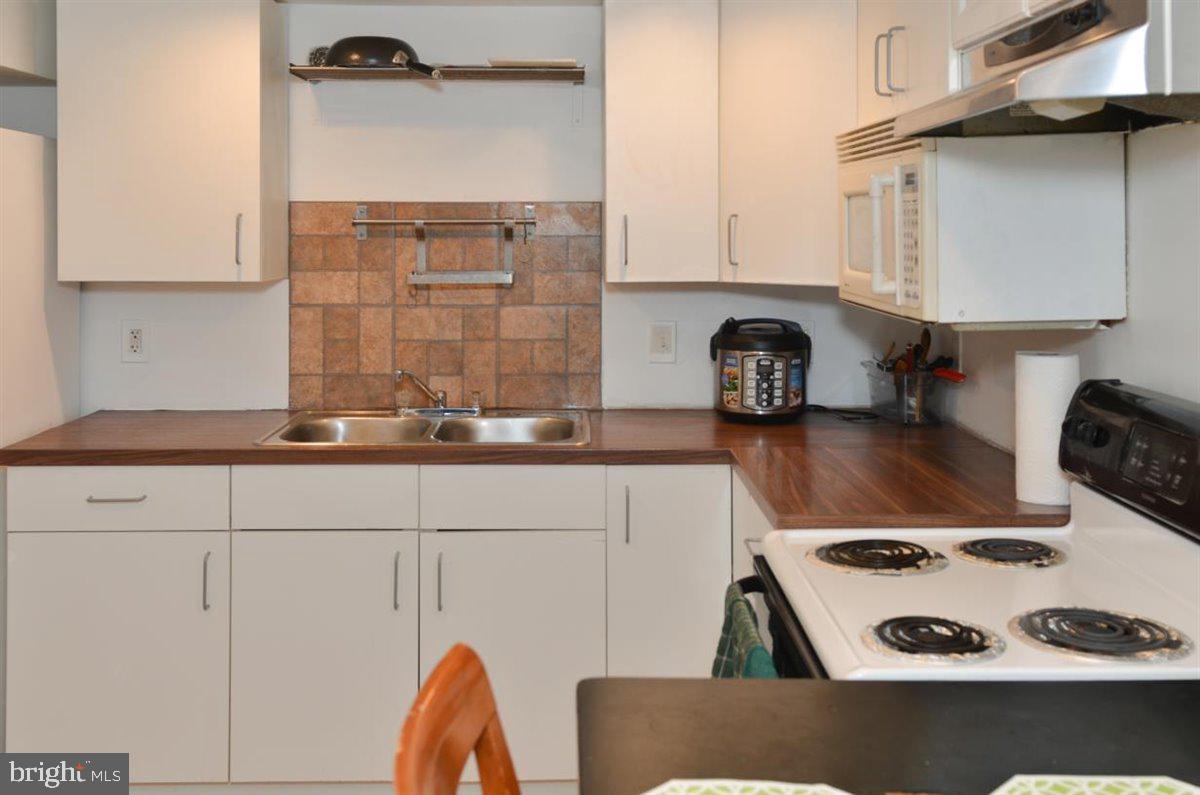 3312 Clay Street Silver Spring, MD 20902 - Photo 28 of 35 a kitchen with a stove and cabinets