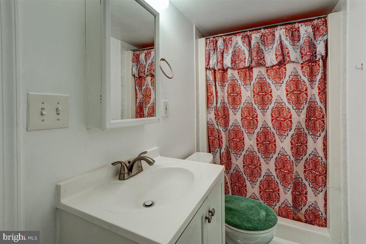 3312 Clay Street Silver Spring, MD 20902 - Photo 30 of 35 a bathroom with a sink and mirror with toilet