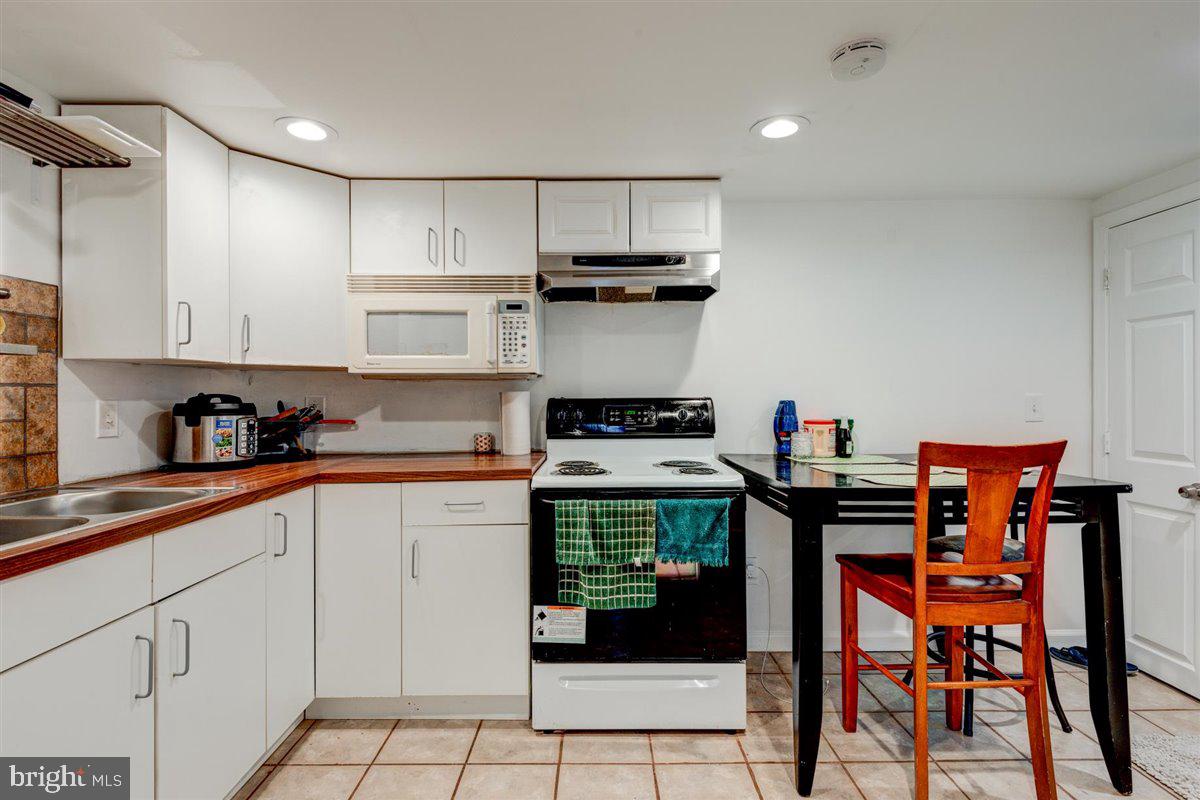 3312 Clay Street Silver Spring, MD 20902 - Photo 33 of 35 a kitchen with stainless steel appliances granite countertop a stove and cabinets