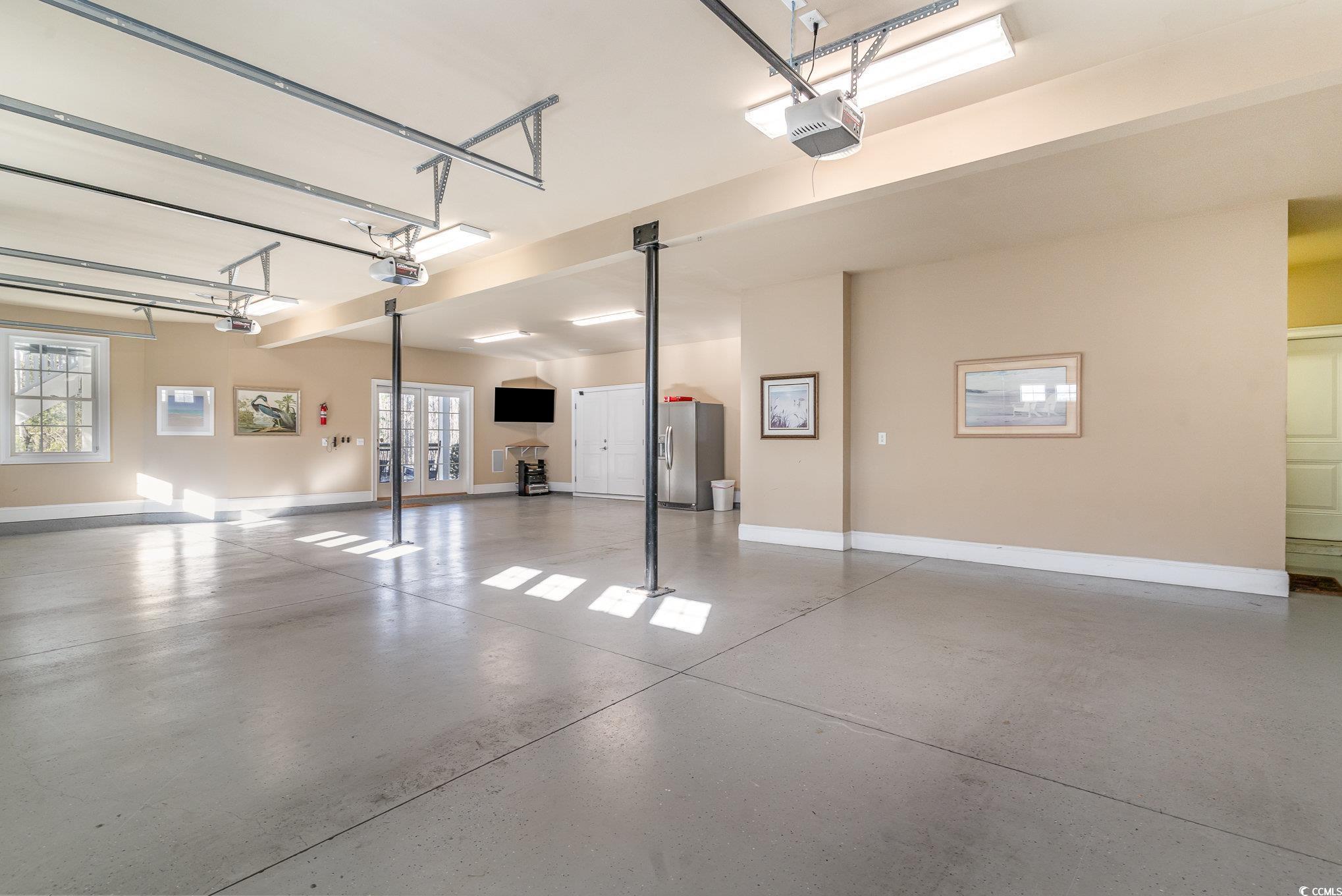 80 Stonington Drive Murrells Inlet, SC 29576 - Photo 28 of 40 Very large garage 3 bays one of which is tandem 2 cars deep. Surround sound o this level as well.