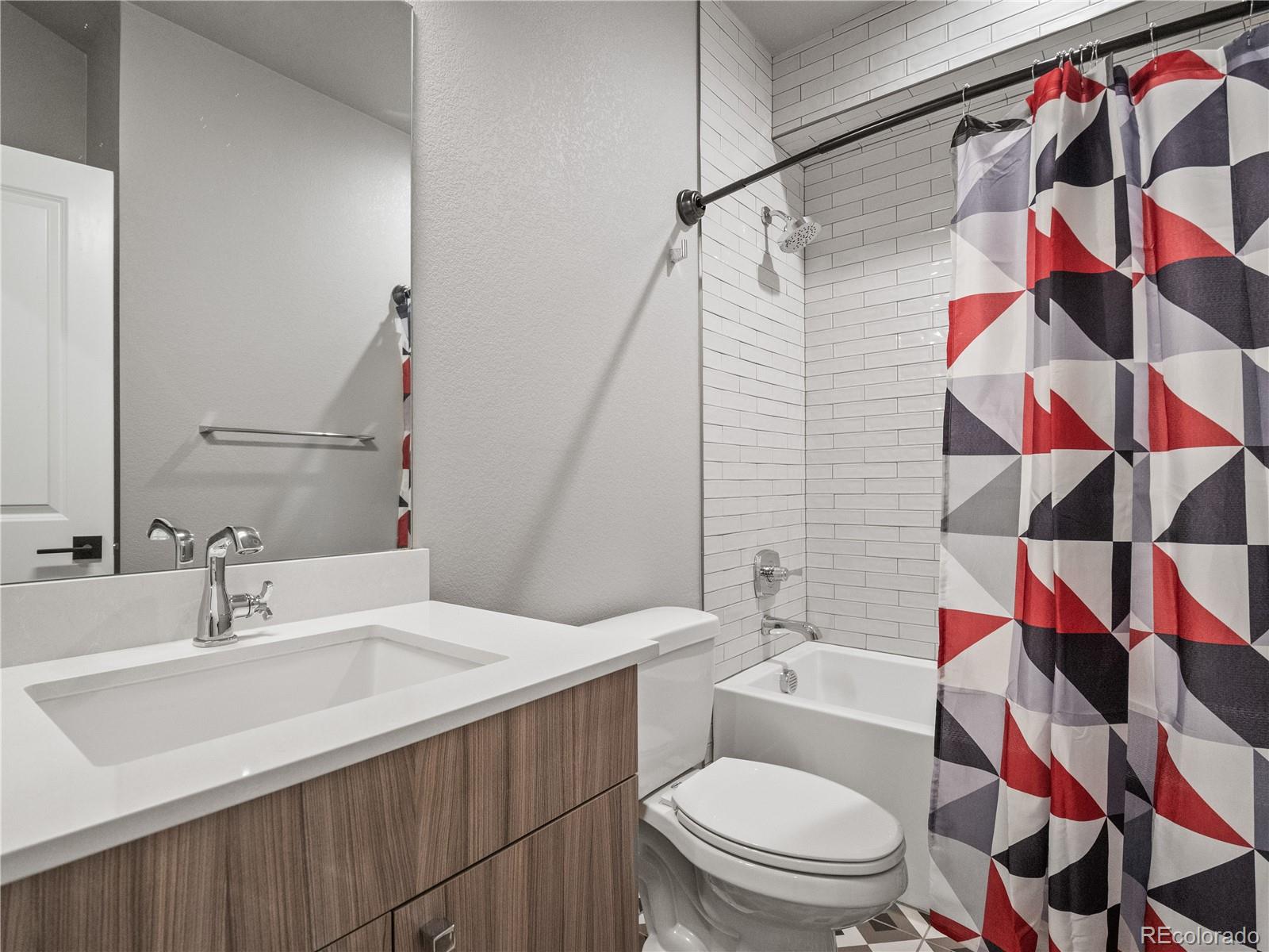 1284 Stuart Street Denver, CO 80204 - Photo 13 of 27 a bathroom with a sink and a mirror