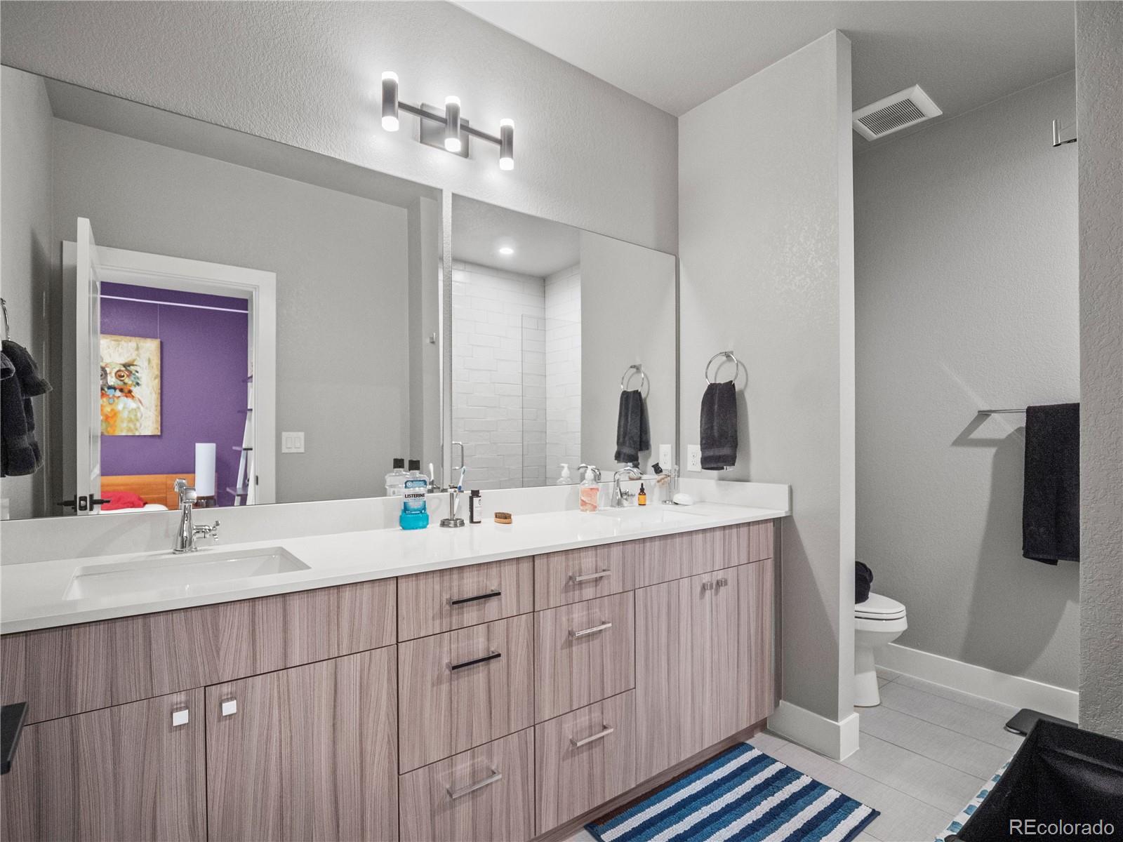 1284 Stuart Street Denver, CO 80204 - Photo 16 of 27 a bathroom with a double vanity sink and a mirror
