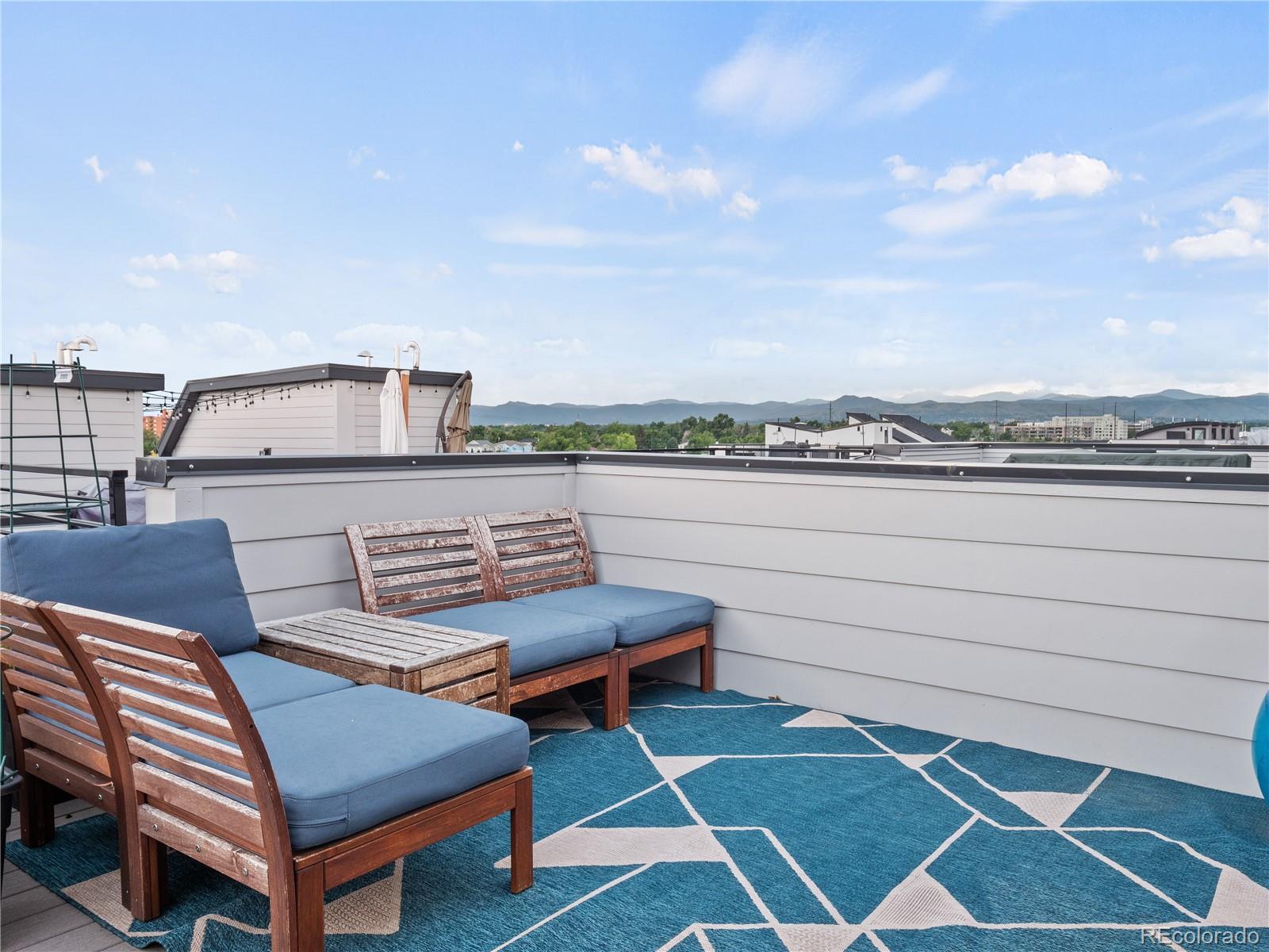 1284 Stuart Street Denver, CO 80204 - Photo 18 of 27 a roof deck with a couch and chairs