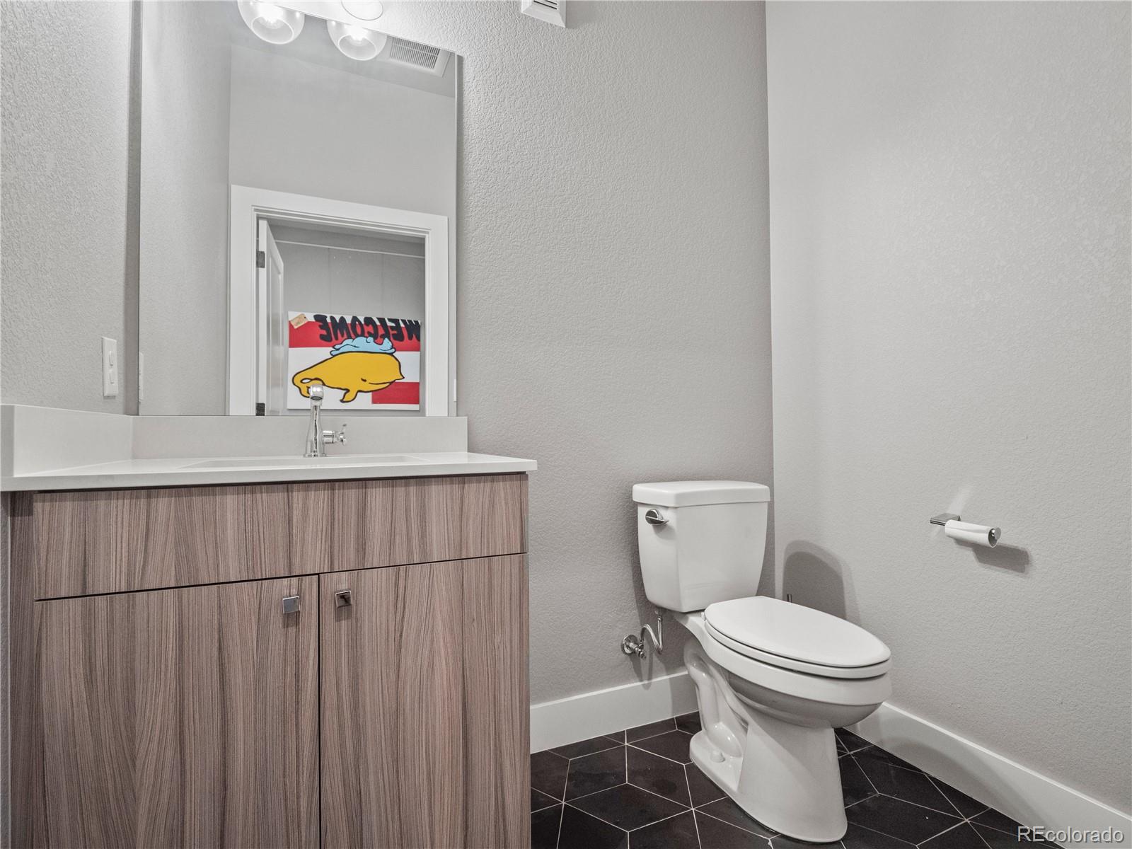1284 Stuart Street Denver, CO 80204 - Photo 4 of 27 a bathroom with a toilet and a sink