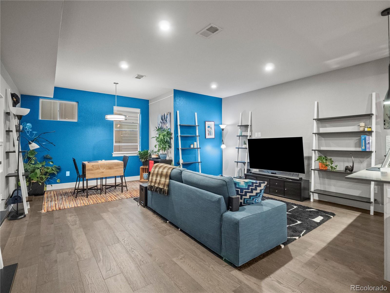 1284 Stuart Street Denver, CO 80204 - Photo 5 of 27 a living room with furniture and a flat screen tv