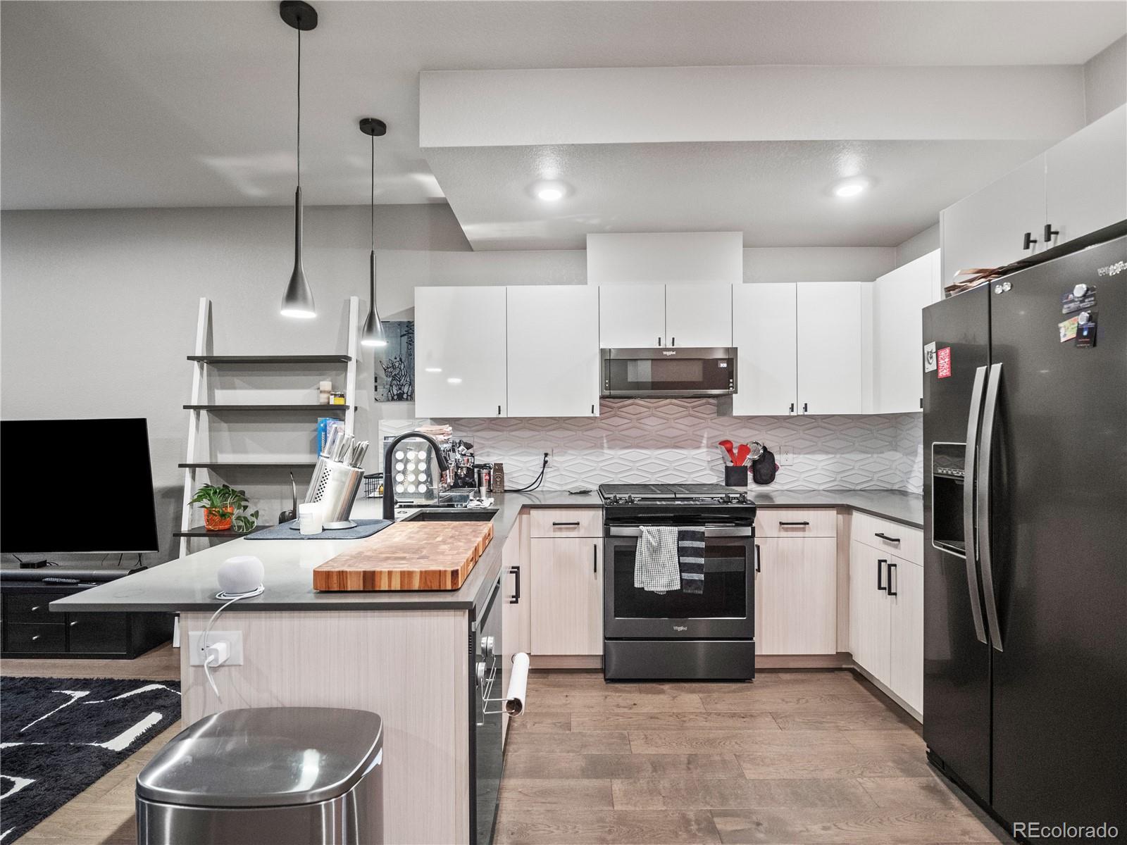 1284 Stuart Street Denver, CO 80204 - Photo 6 of 27 a kitchen with a sink stainless steel appliances and cabinets