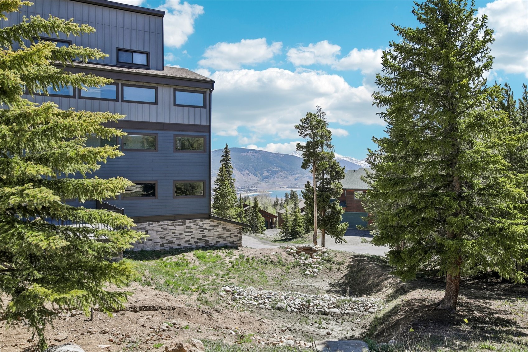 89310 Ryan Gulch Road, Unit 103 Silverthorne, CO 80498 - Photo 22 of 48 a view of a brick house with a yard