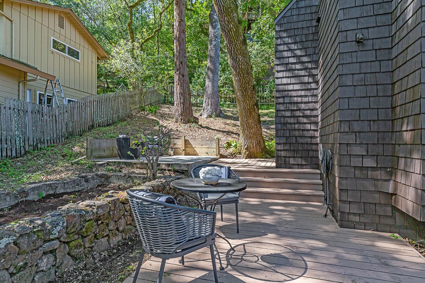 128 Los Trancos Circle Portola Valley, CA 94028 - Photo 24 of 38 a view of a patio with a table and chairs