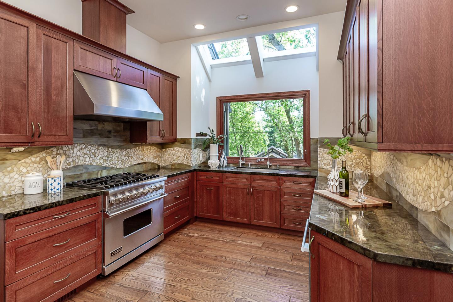128 Los Trancos Circle Portola Valley, CA 94028 - Photo 5 of 38 a kitchen with stainless steel appliances granite countertop wooden cabinets a stove top oven a sink and dishwasher