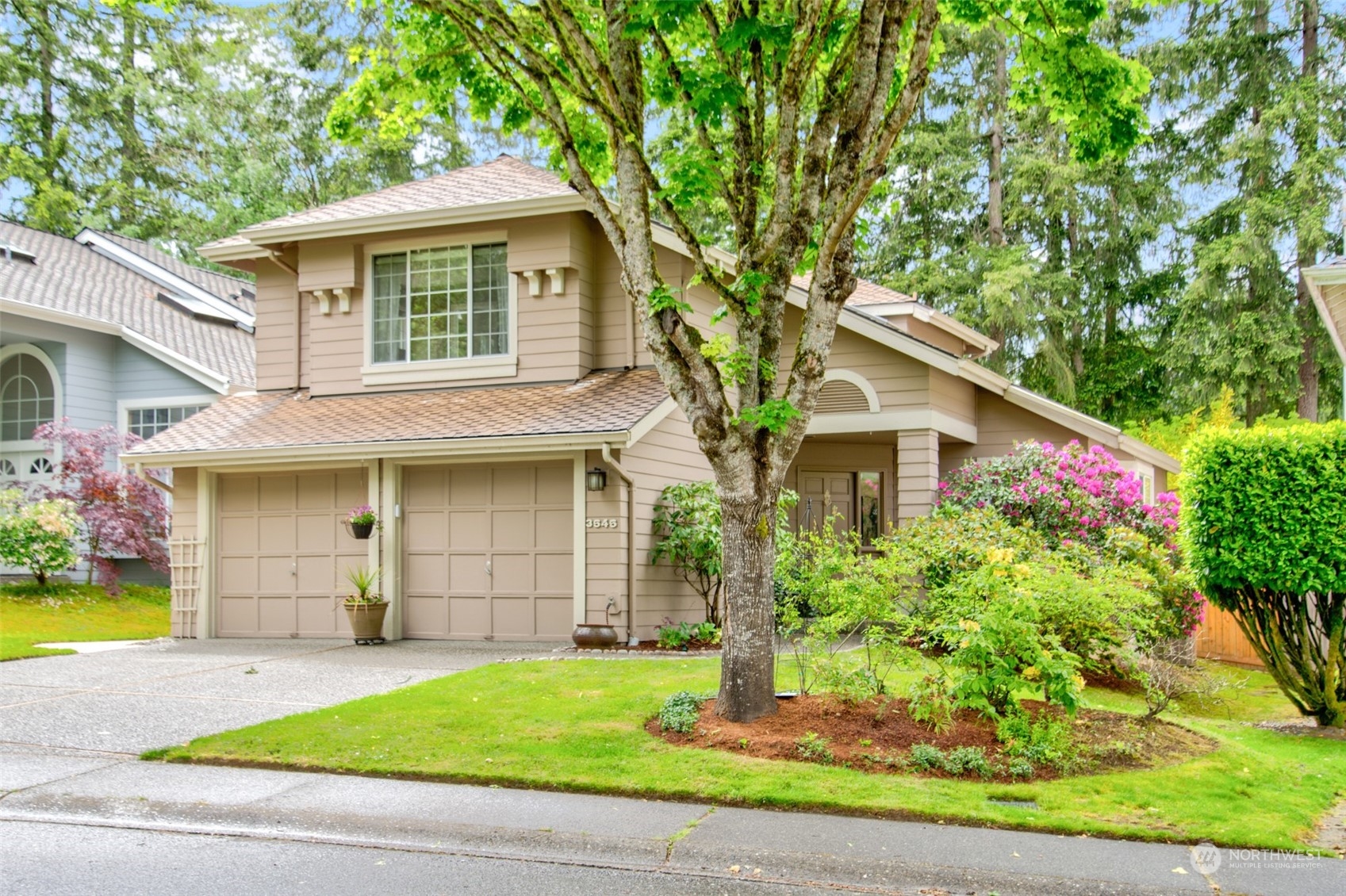 3545 252nd Place Southeast Sammamish, WA 98029 - Photo 2 of 31 a front view of a house with a yard and garage