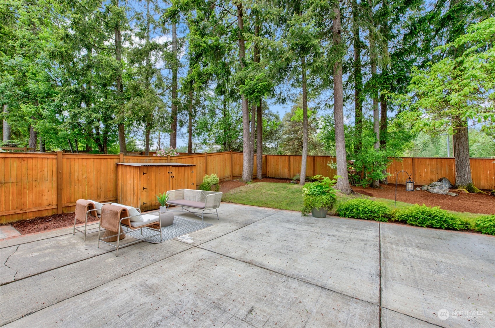 3545 252nd Place Southeast Sammamish, WA 98029 - Photo 24 of 31 a view of a patio with table and chairs potted plants and large tree