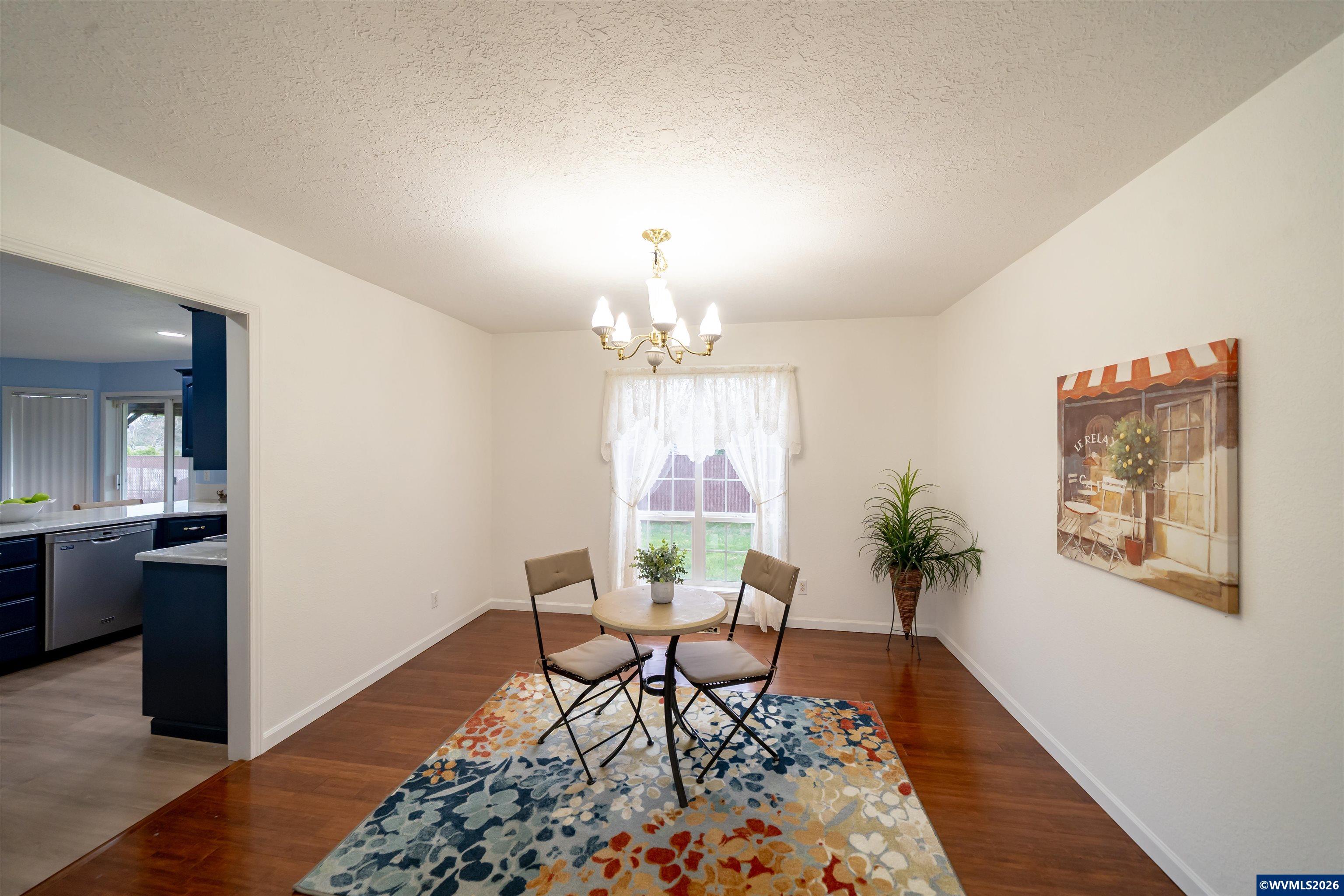 312 Southwest Cascade Meadow Drive Sublimity, OR 97385 - Photo 5 of 42 a living room with furniture and a chandelier