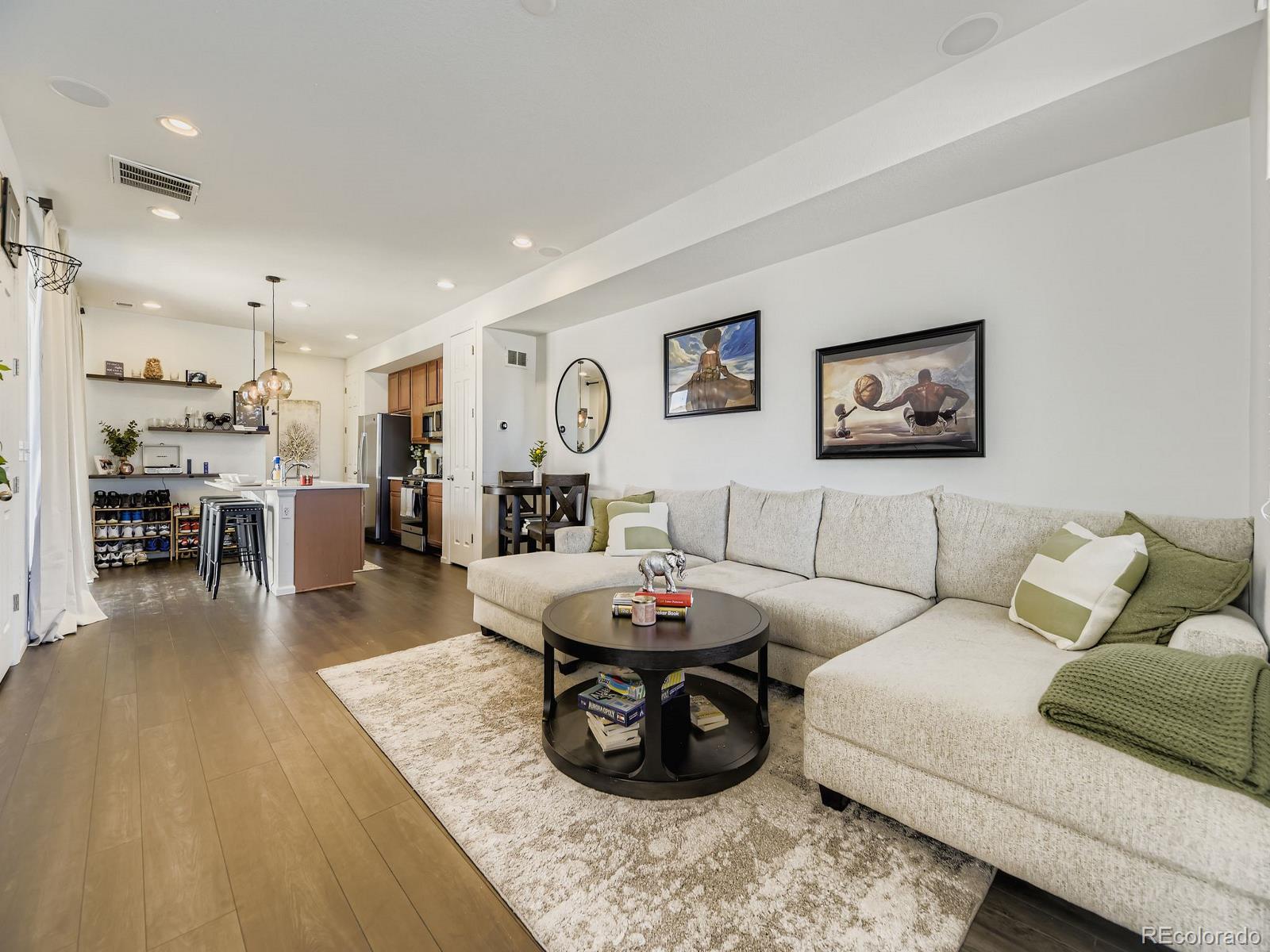 1680 South Tower Road Aurora, CO 80017 - Photo 12 of 26 a living room with furniture and a dining table with wooden floor