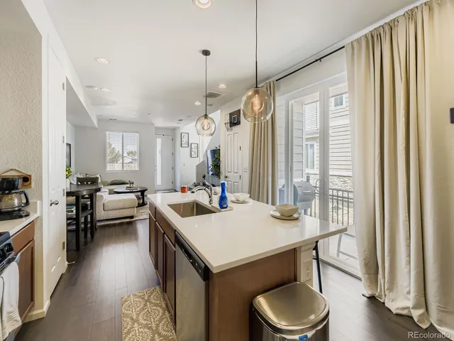 a kitchen with a table chairs stove and wooden floor