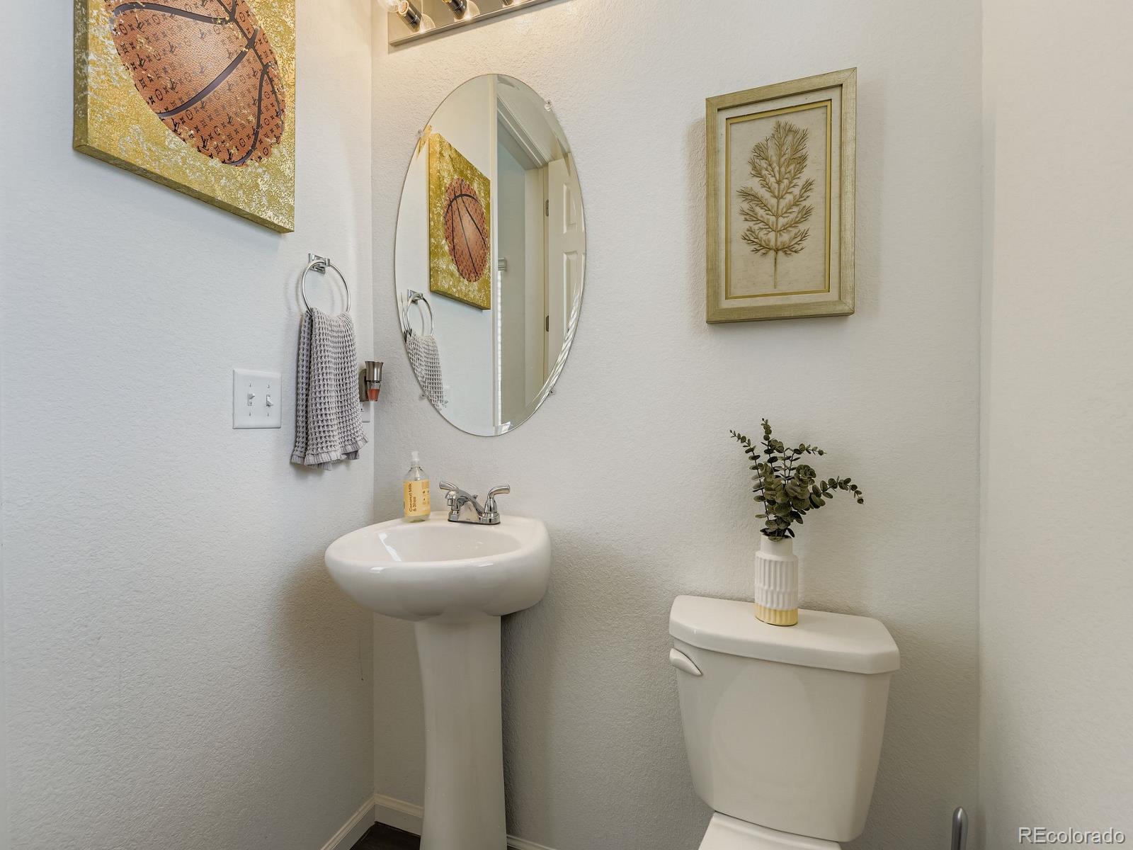 1680 South Tower Road Aurora, CO 80017 - Photo 15 of 26 a bathroom with a toilet sink and mirror