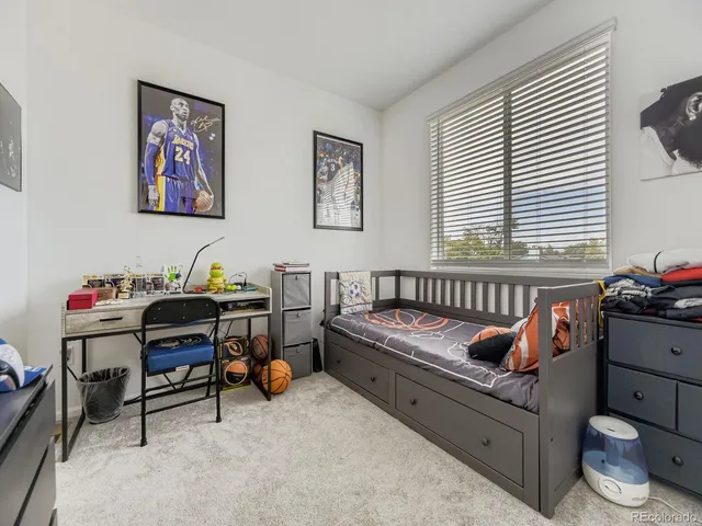 a bedroom with furniture and a window