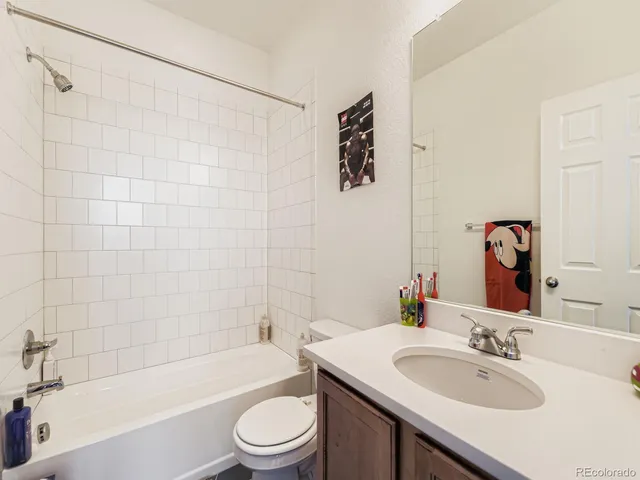 a bathroom with a sink a toilet and bathtub